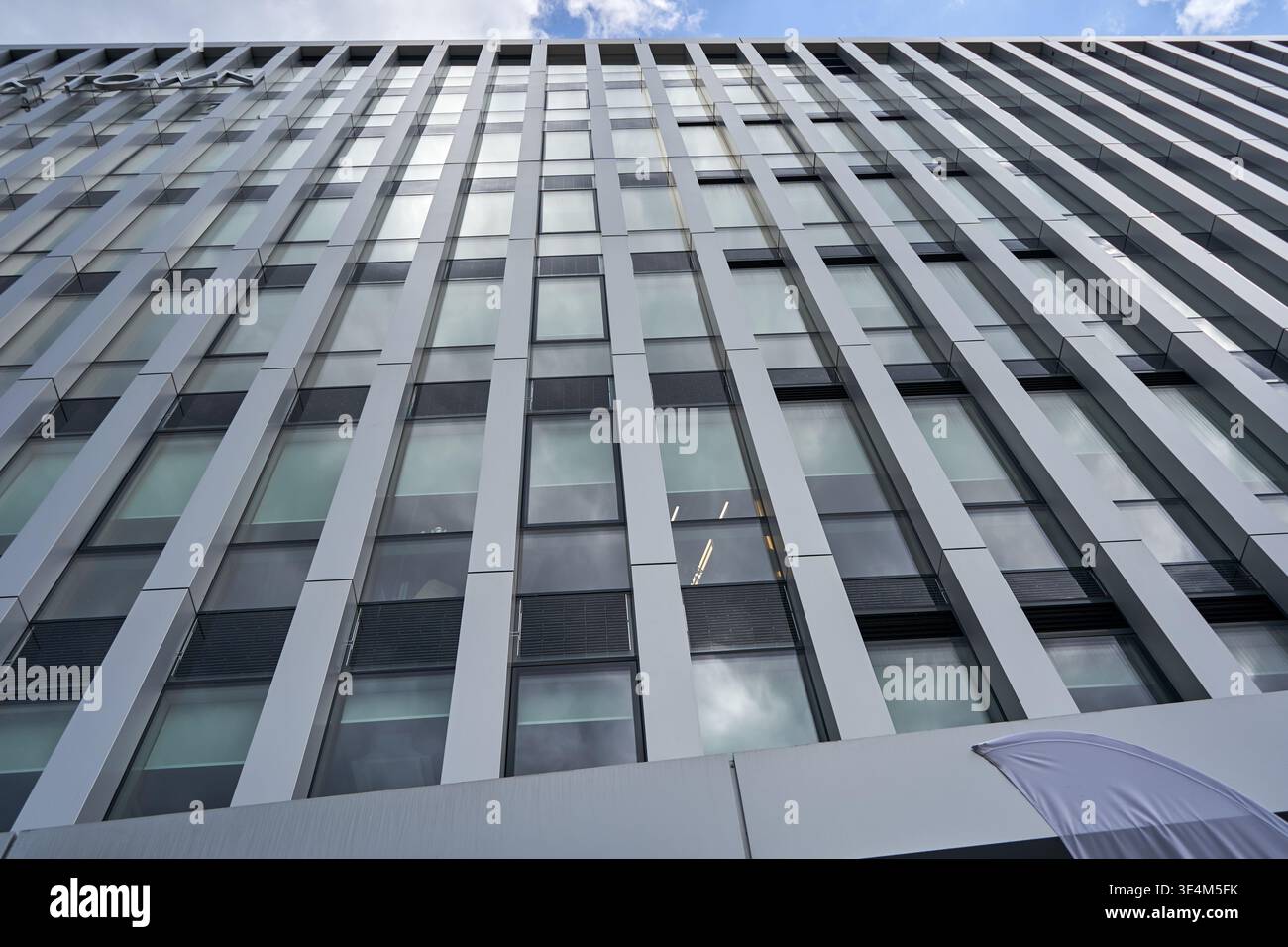 Modern corporate office building facade featuring a geometric grid ...