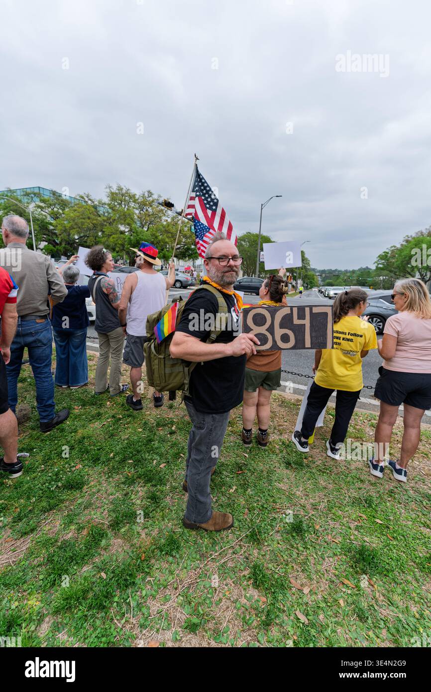 Tallahassee, FL, USA. 28th Mar 2026. A man holds a sign reading 