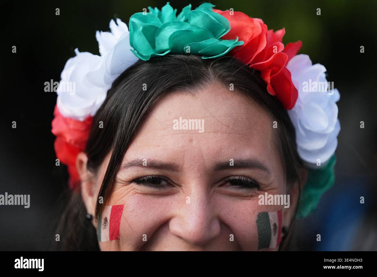A fan poses for photos as she arrives to the Azteca Stadium for the ...