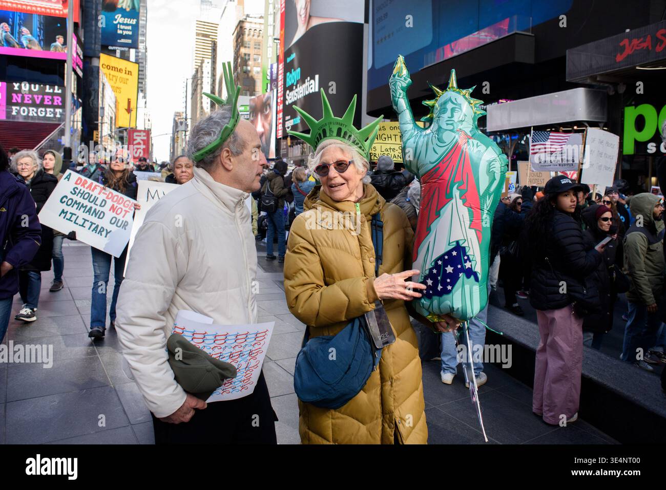 Two protestors wear crowns matching that of the Statue of Liberty while ...