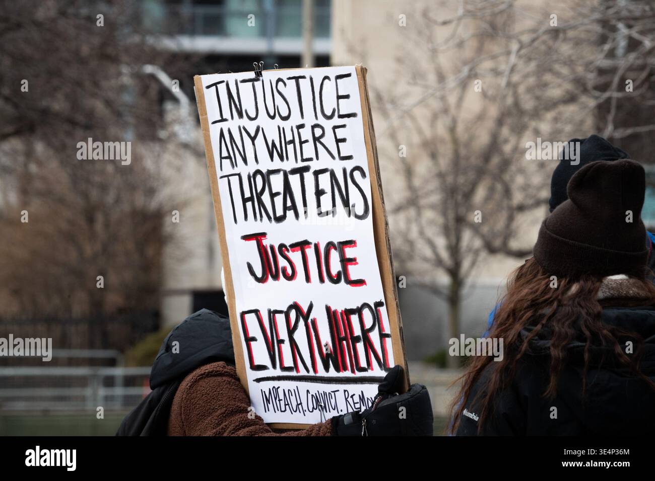 A protest sign refers to “Injustice” during the ‘No Tyrants’ rally in ...