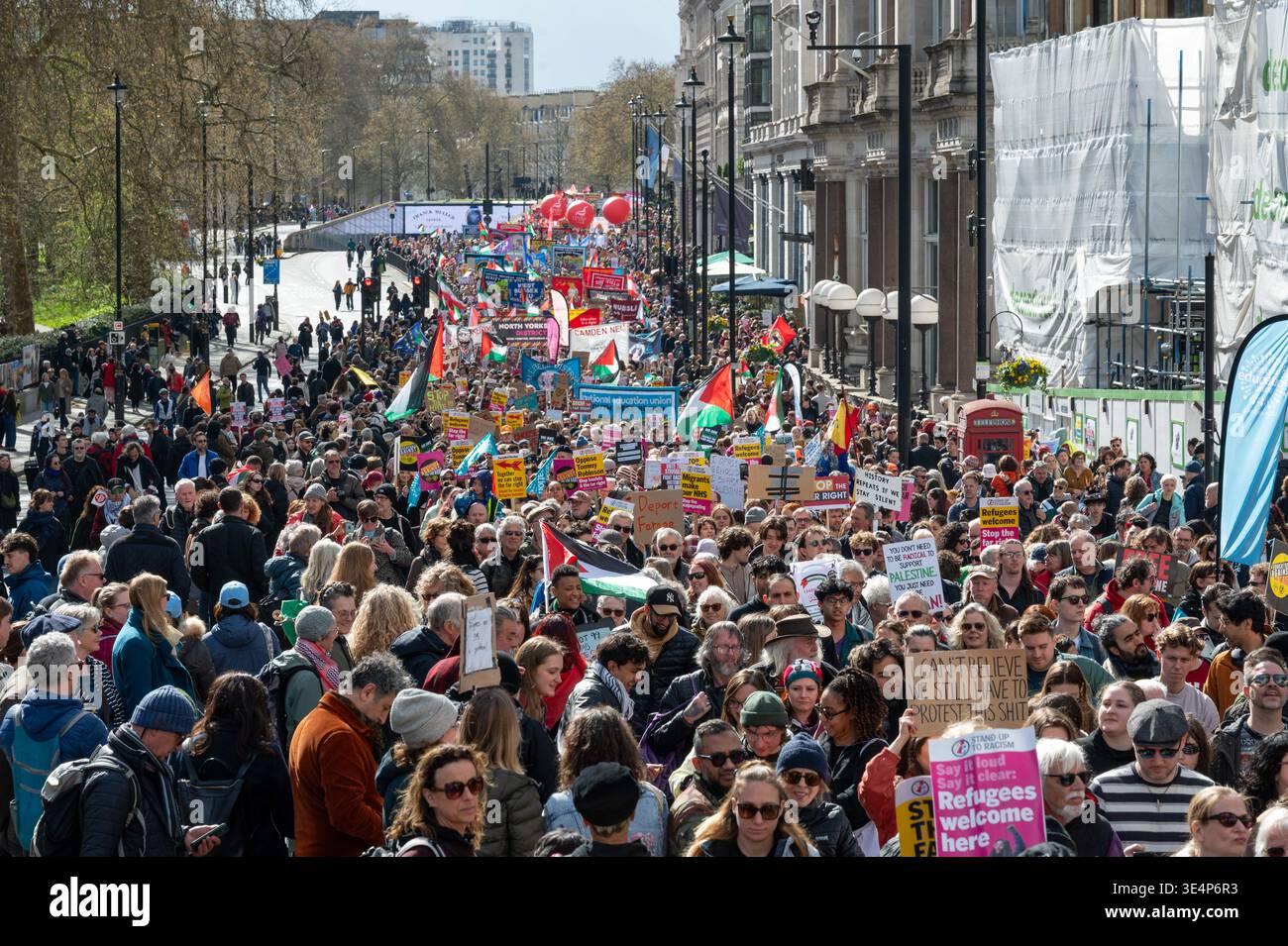 Large crowd marches toward Downing Street. Protesters attend a march ...
