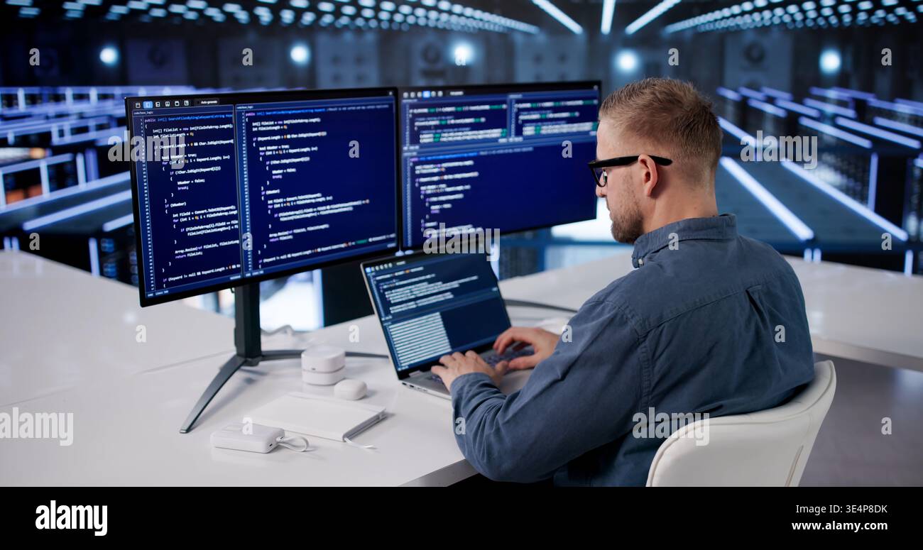IT Professional Managing Cloud Data Protection In Advanced Server Facility Stock Photo