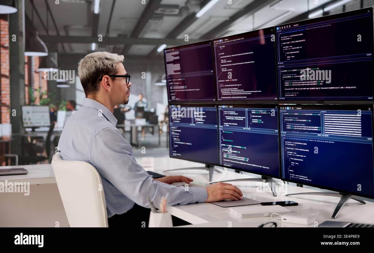 Hispanic Software Engineer Writing Code For Modern Web Apps On Desktop Monitor Stock Photo