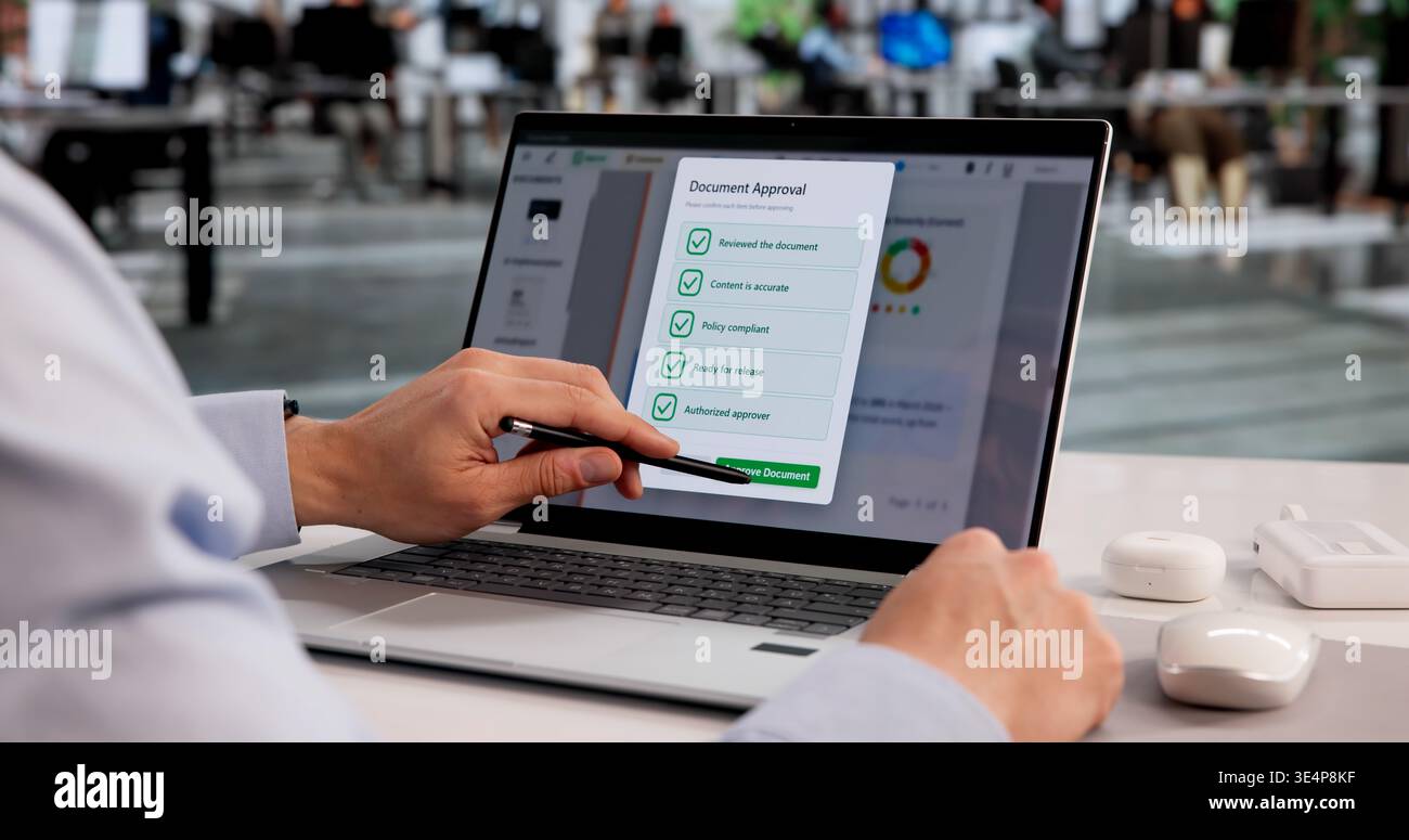 Young Hispanic Male Reviewing And Approving Documents Using Cloud-Based Checklist Software On Laptop Stock Photo