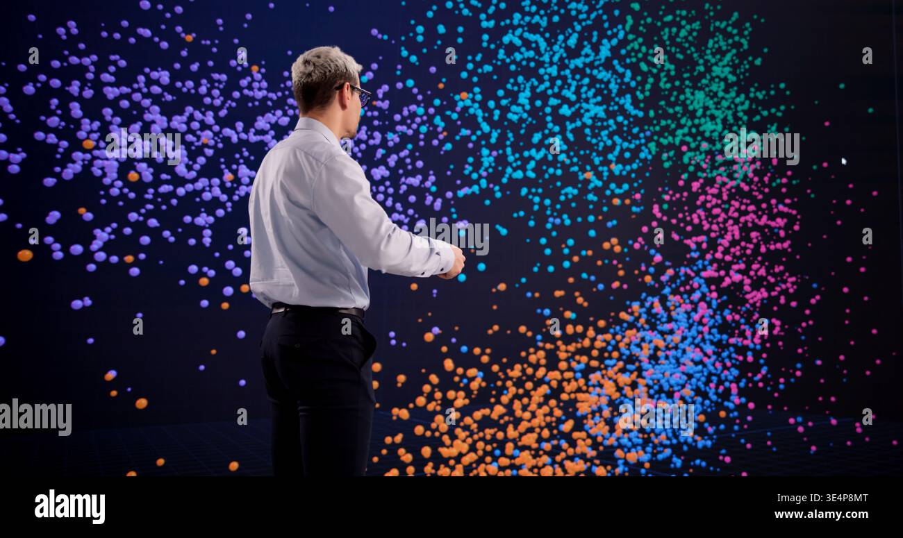 Hispanic Man Exploring Big Data Clustering Techniques On An Interactive Display Stock Photo