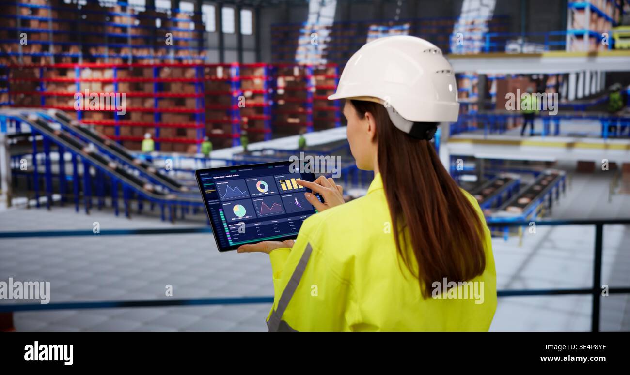 Warehouse Supervisor Analyzing Inventory Metrics On Tablet For Streamlined Supply Chain Operations Stock Photo