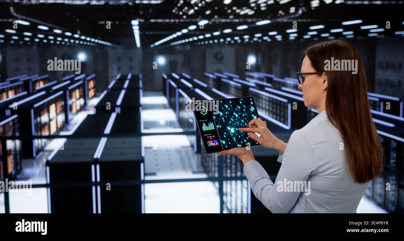 Female Engineer Oversees AI Training Processes In Secure Data Center Stock Photo