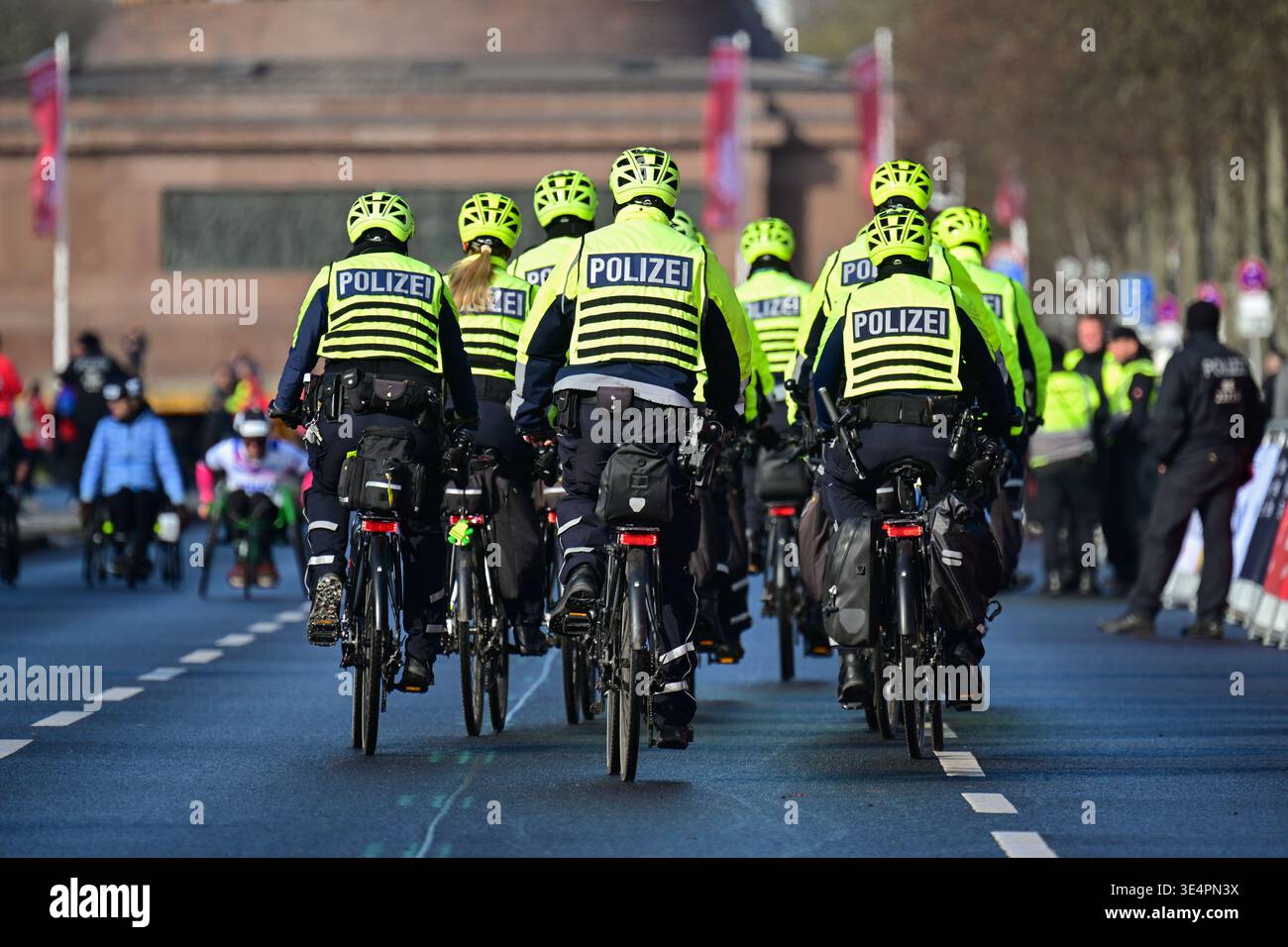 29 March 2026, Berlin: Police officers ride bicycles towards the ...
