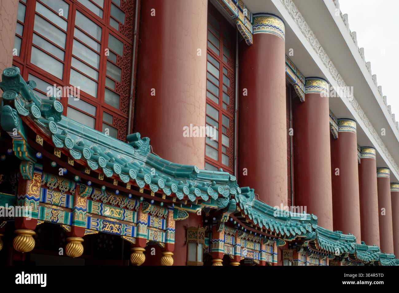 Grand building with red pillars and green tiled roof. Traditional ...