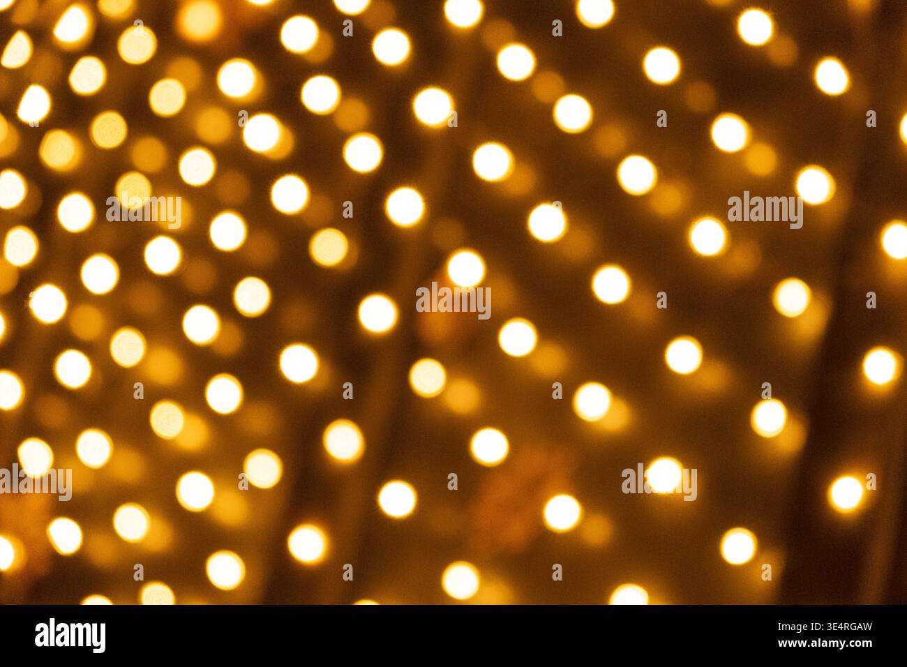 Festive Golden Light Dots Pattern for Holiday Design. Stock Photo