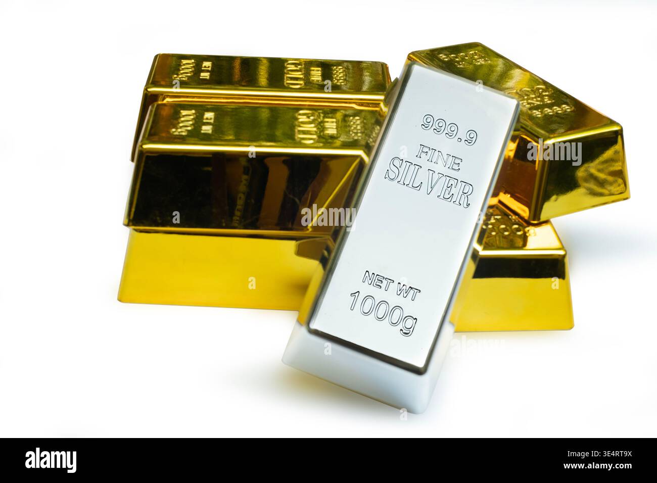 Fine silver bar leaned against a gold bars Stock Photo