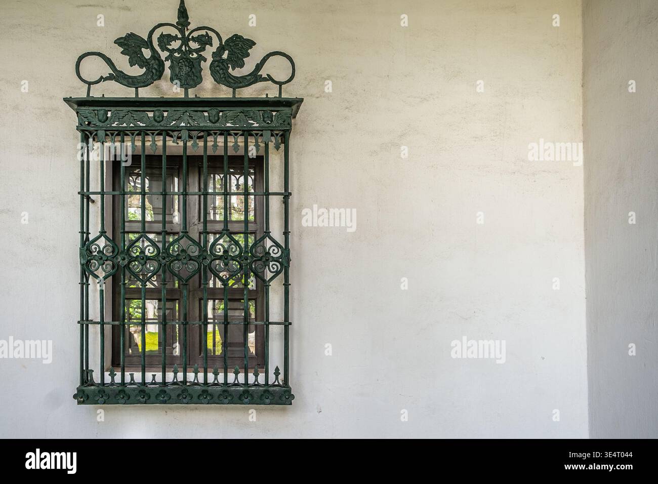 Window with iron bars and painted frame Stock Photo