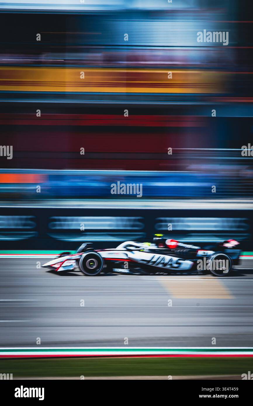Haas Formula 1 car speeding on track with motion blur, capturing the high-speed essence of professional grand prix racing. Imola Stock Photo