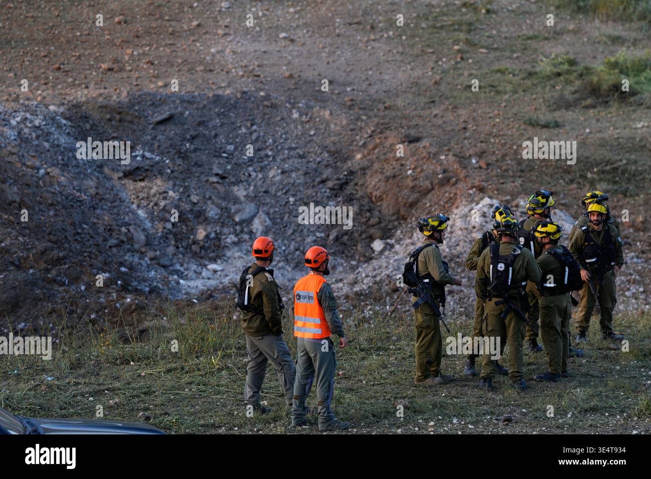 Israeli security forces work at the site of an Iranian missile strike ...