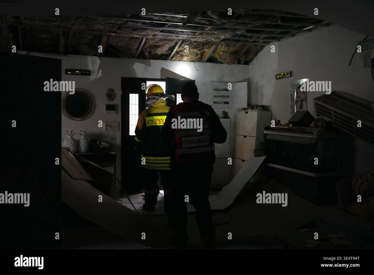 Israeli security forces work at the site of an Iranian missile strike ...