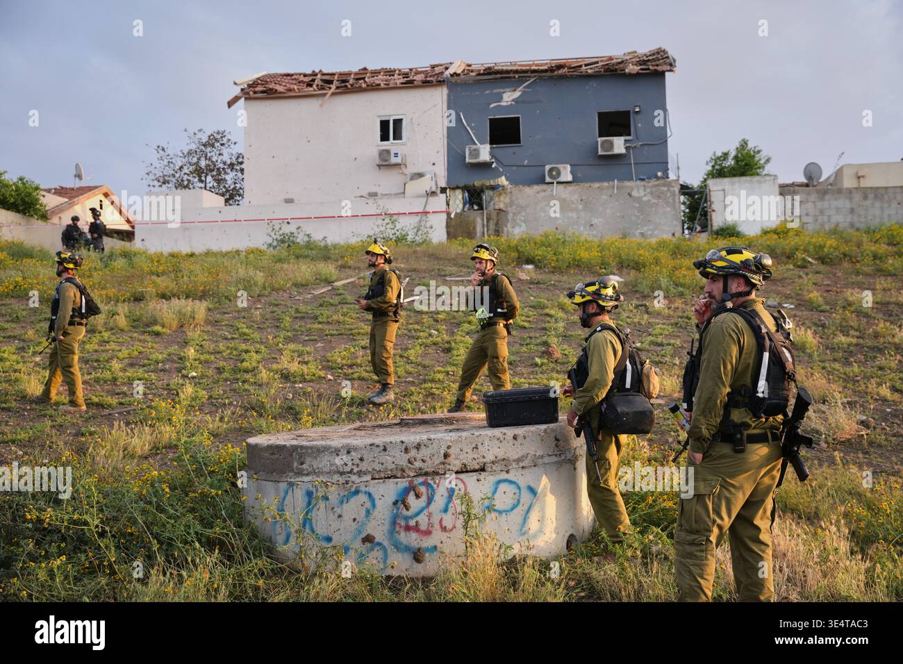 Israeli security forces work at the site of an Iranian missile strike ...