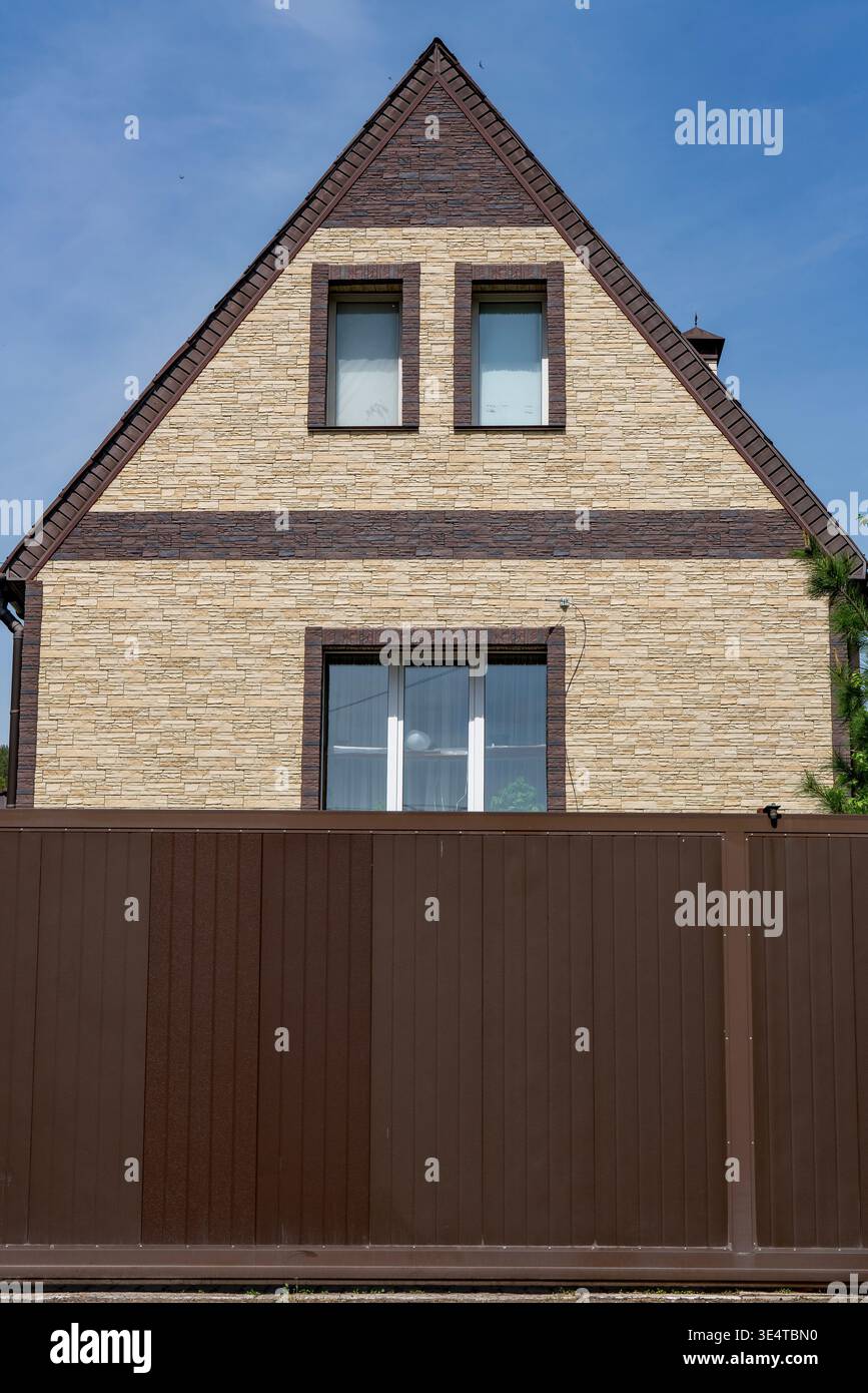 Triangular Big Cladding A modern residential house facade featuring beige stone cladding ...