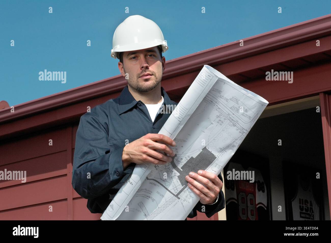 Engineering contactor supervisor with blueprints plans, USA Stock Photo