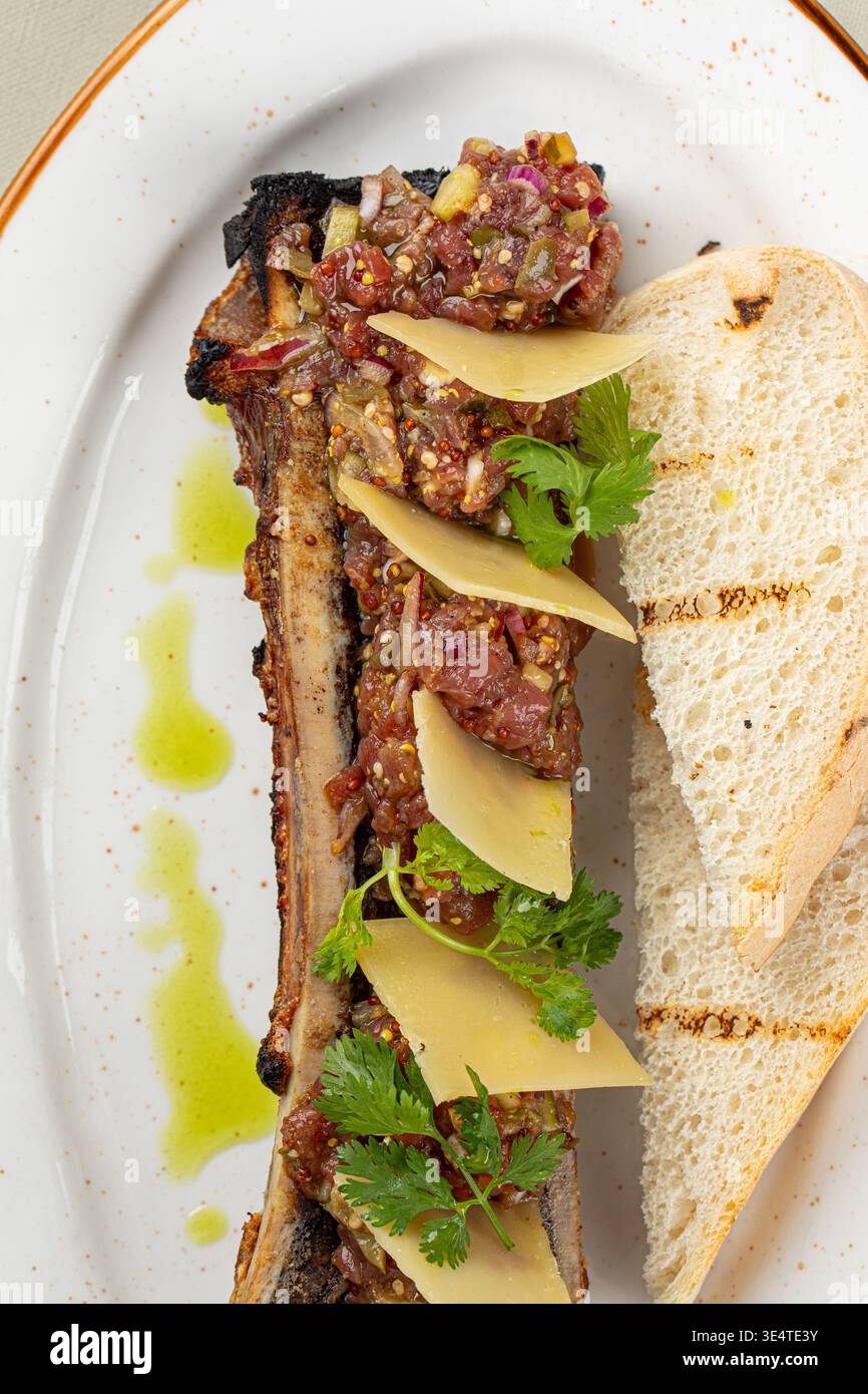 Bone marrow with beef tartare and bread slices Stock Photo