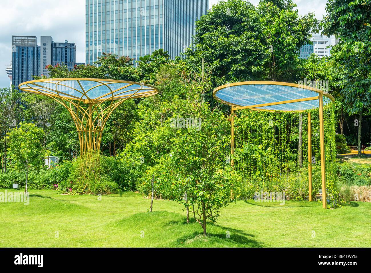 Urban park with modern canopy structures and dense greenery against ...