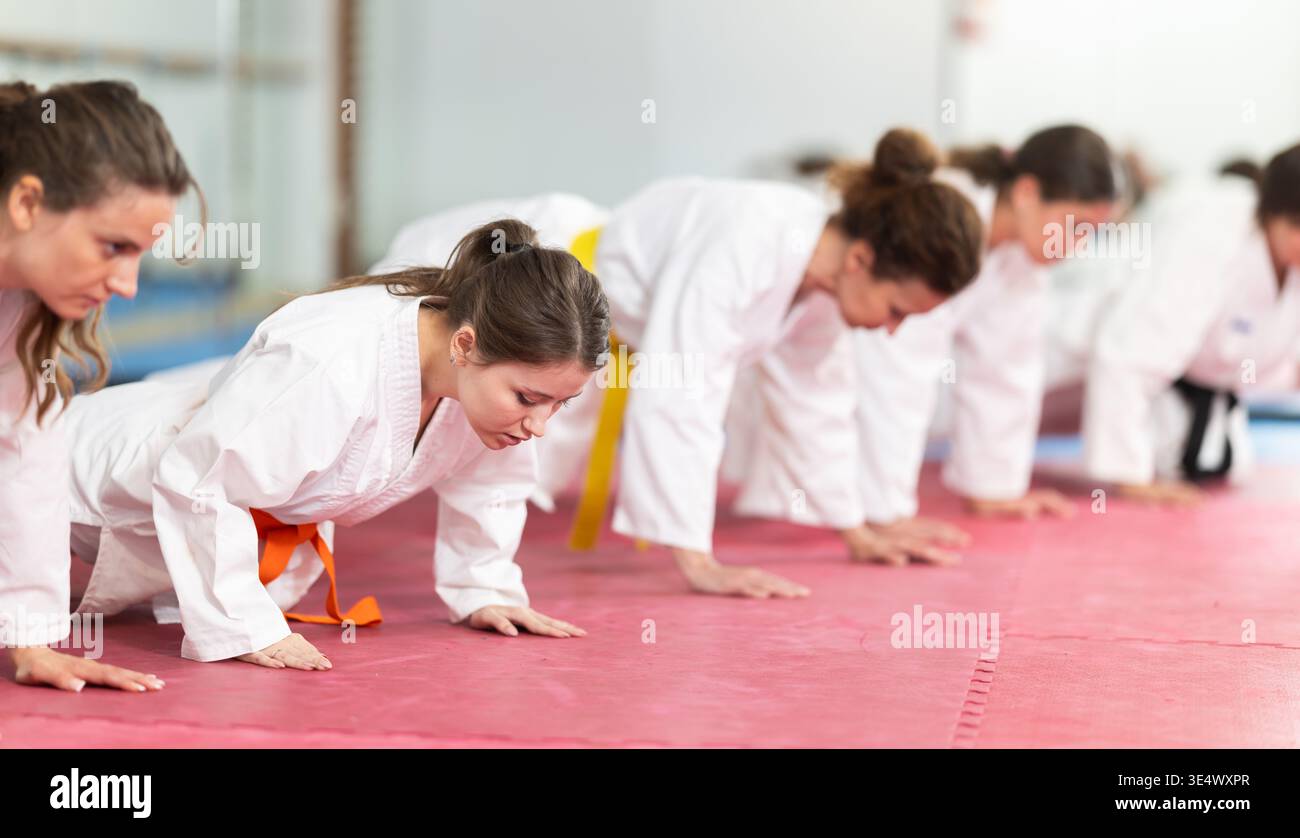 Women doing push-ups in training Stock Photo