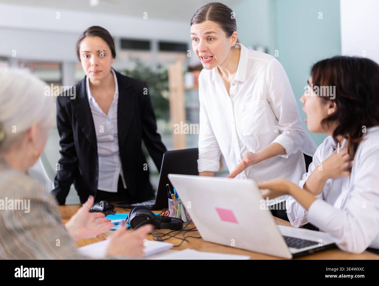 Angry group of female colleagues arguing during office meeting Stock ...