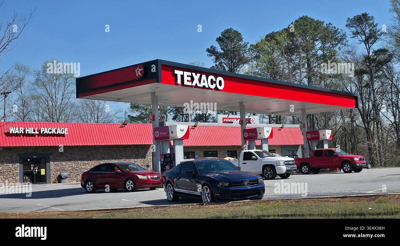 Texaco gas station with parked cars and convenience store in Georgia, USA, everyday American roadside scene - Smartphone Captured Stock Image