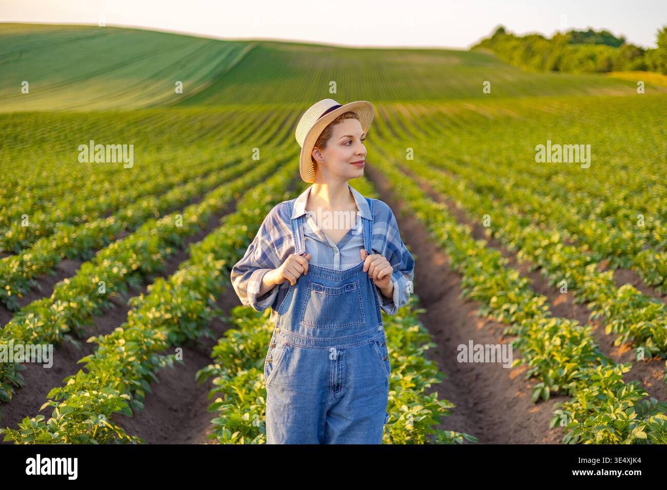 Woman in straw hat overalls hi-res stock photography and images - Alamy