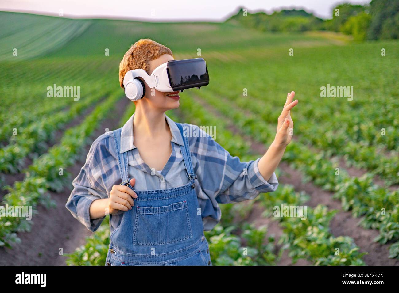 Farmer Using VR Headset in Field Stock Photo