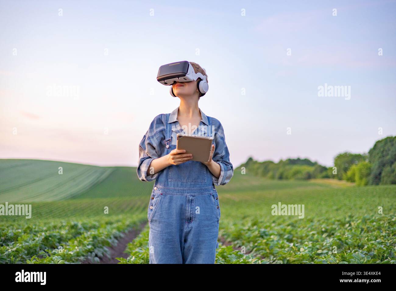 Farmer Using VR Headset in Field Stock Photo