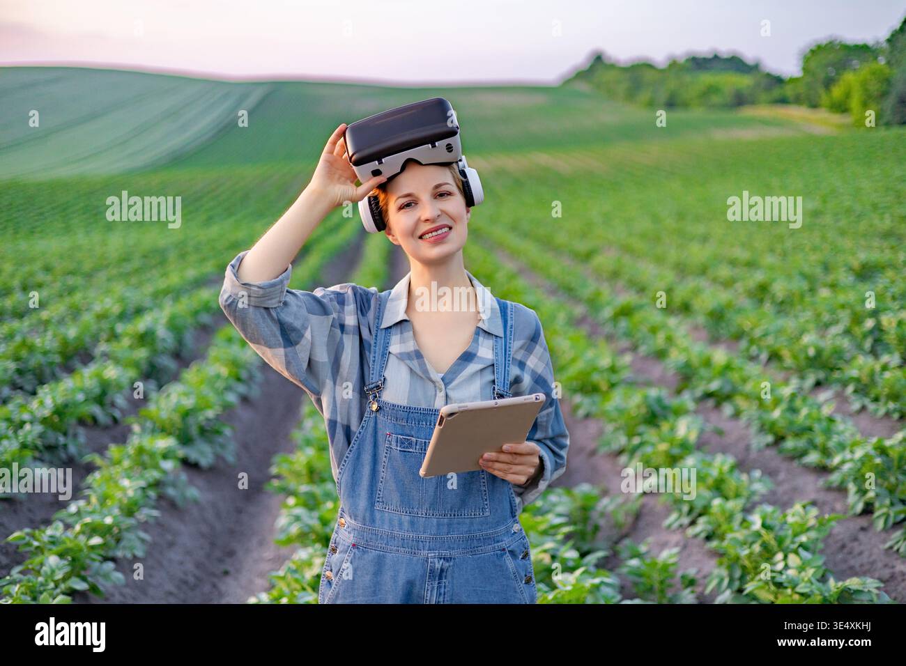 Farmer Using VR Headset in Field Stock Photo