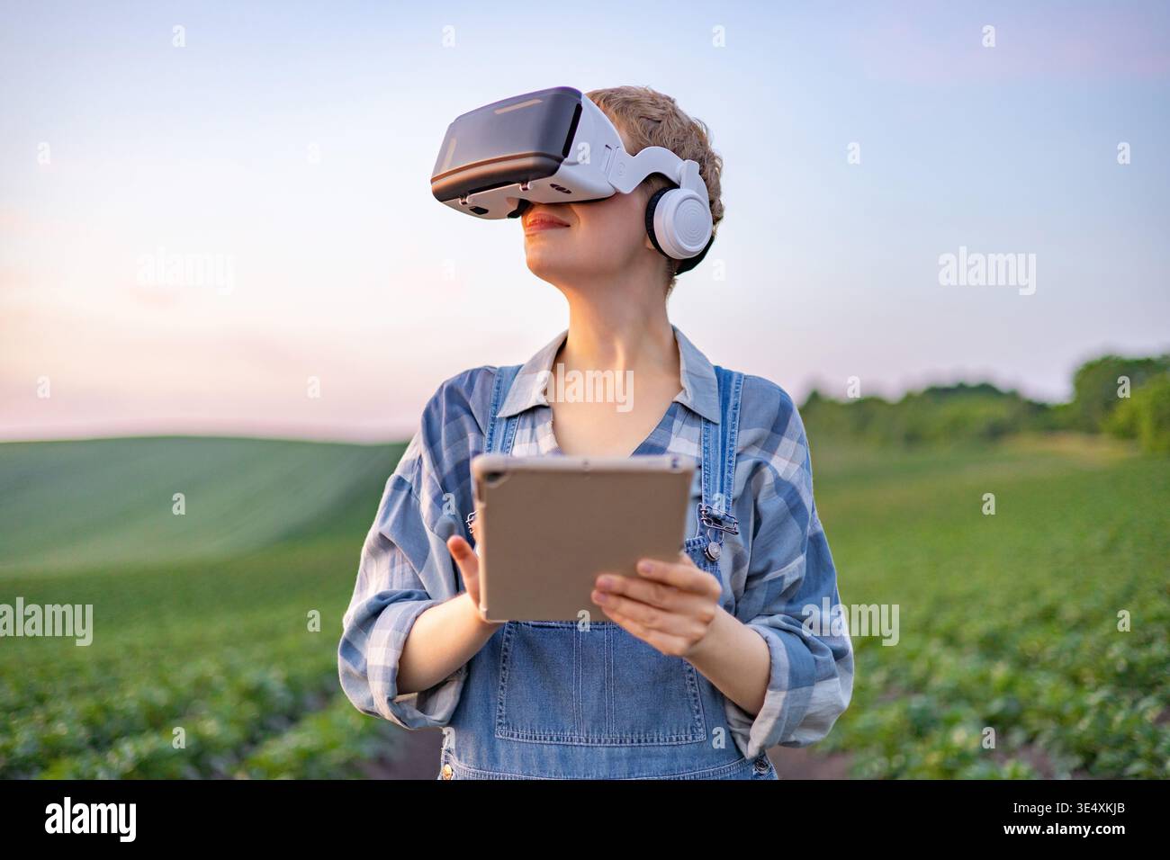 Farmer Using VR Headset in Field Stock Photo