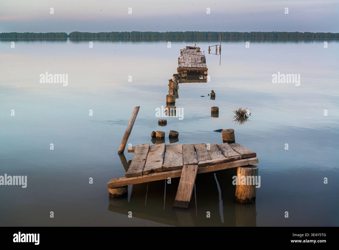 Sunset view of a crumbled jetty in the Gambia river. Tendaba, The Gambia. Stock Photo