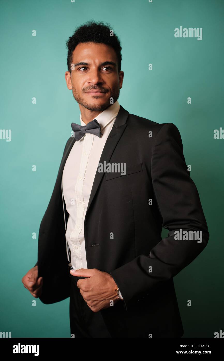 Confident man in a formal suit posing happily Stock Photo
