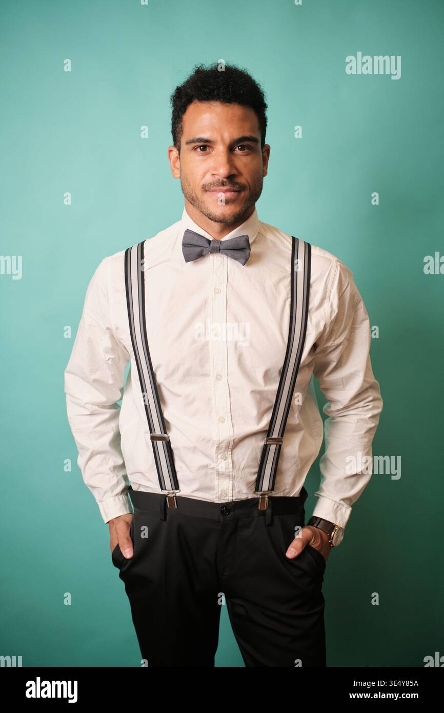 Young man posing in formal style with suspenders Stock Photo
