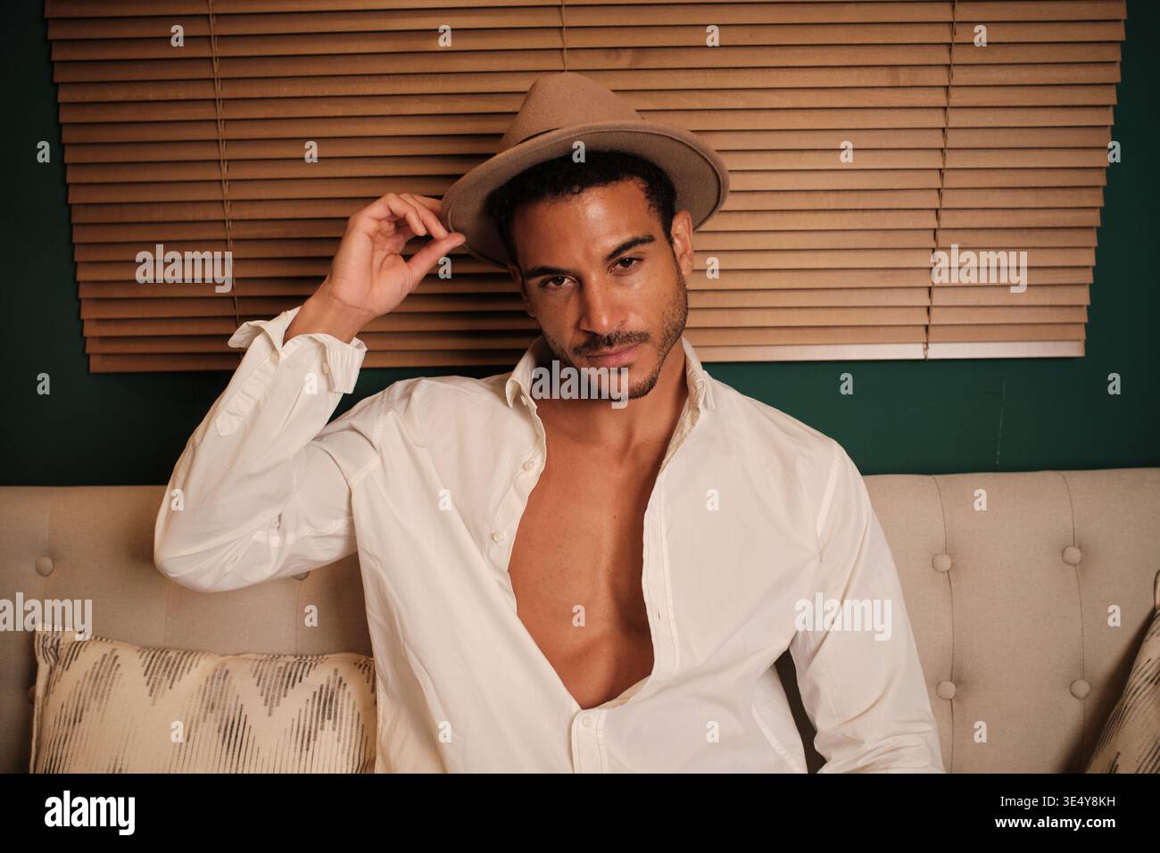 Confident man in fedora posing looking at camera Stock Photo