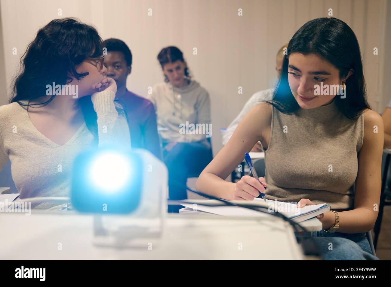 Students learning in classroom with projector for education Stock Photo
