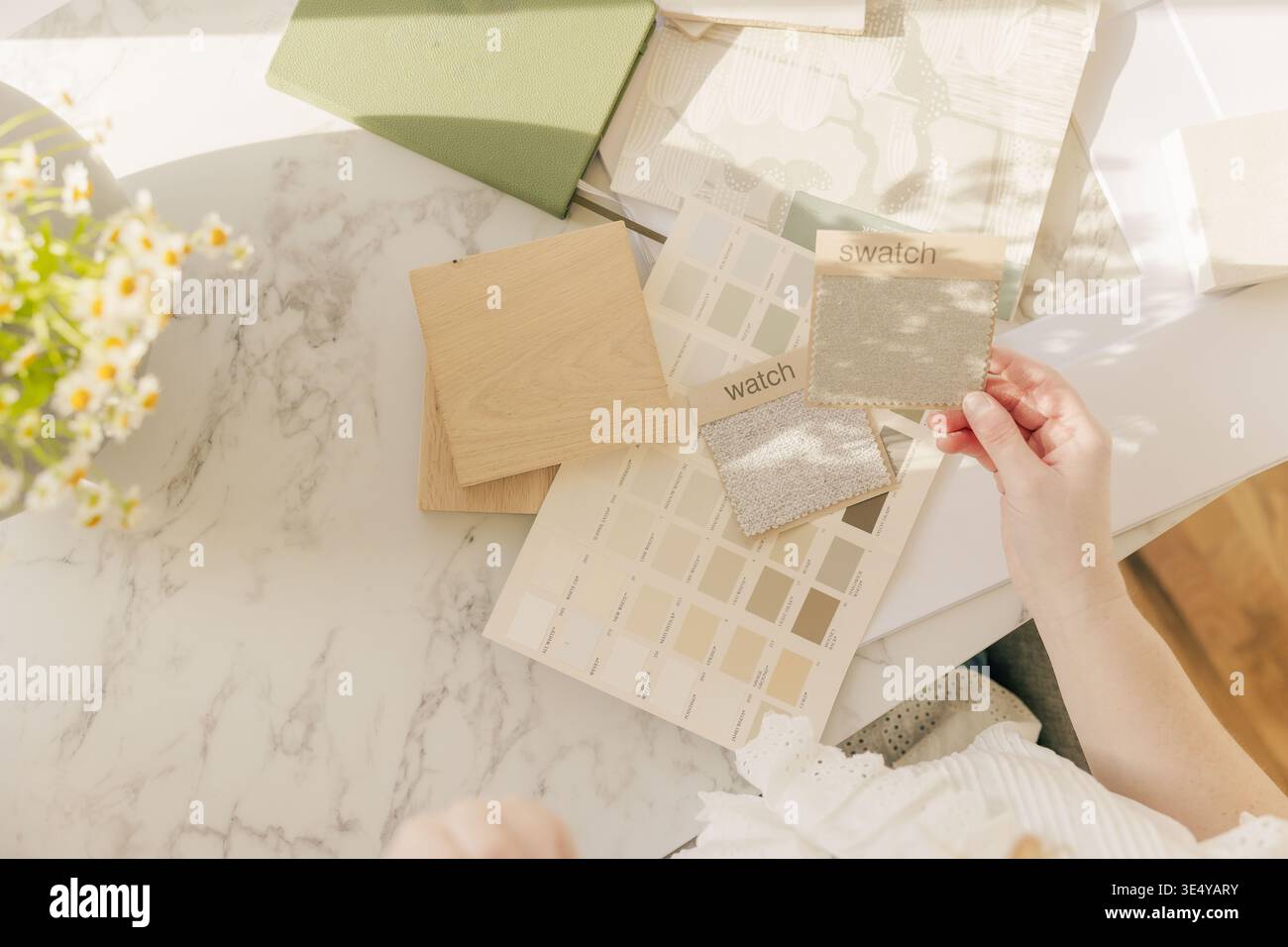 Interior designer choosing neutral fabric swatches Stock Photo