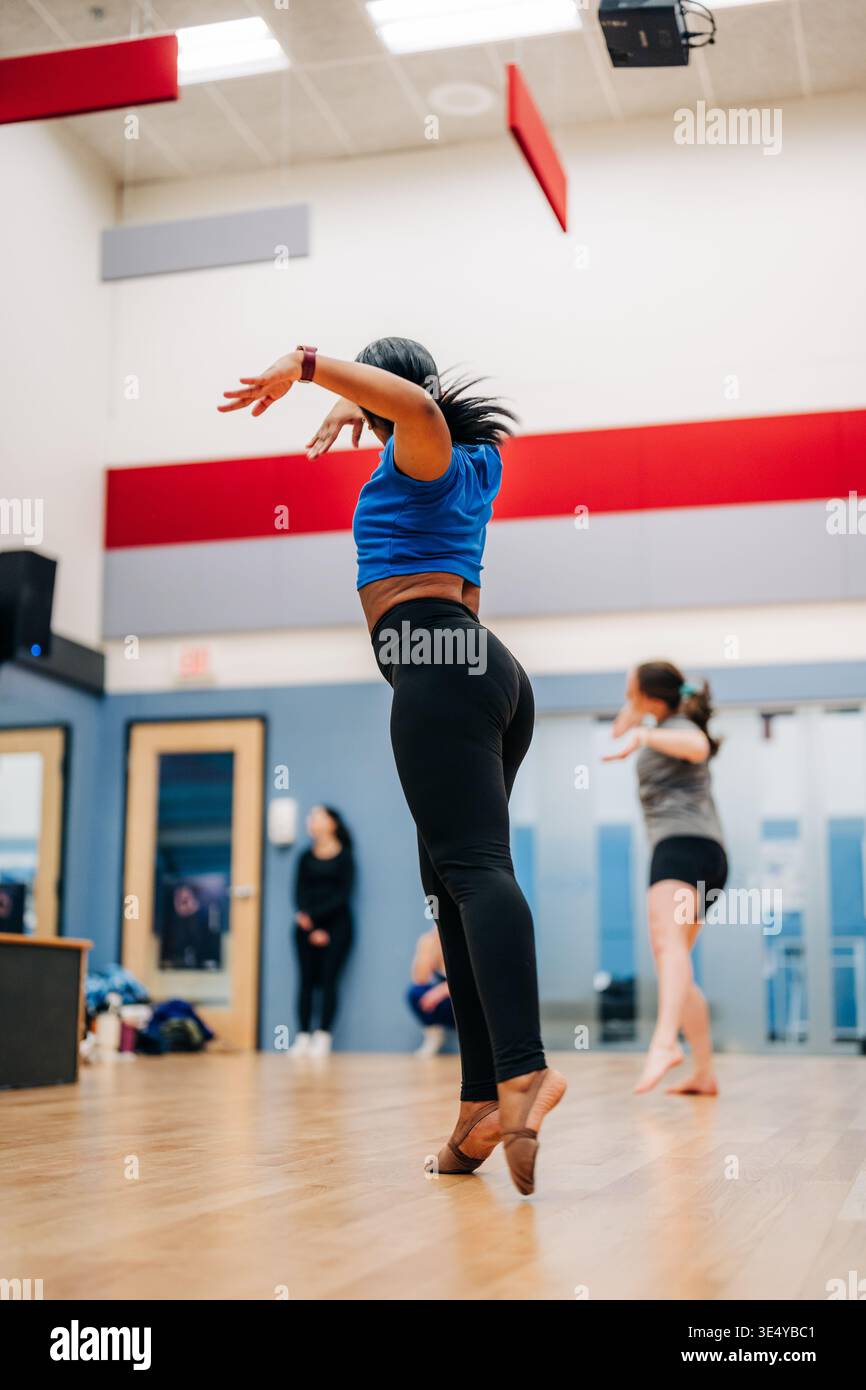 Dancer rehearsing challenging movement in a dance studio Stock Photo