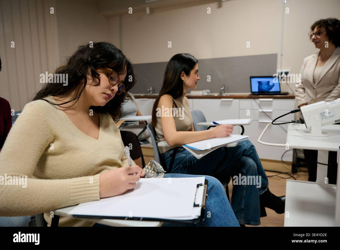 Students learning in a modern university classroom setting Stock Photo