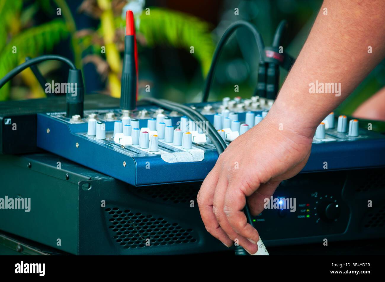 Professional audio engineer adjusting analog mixing console Stock Photo