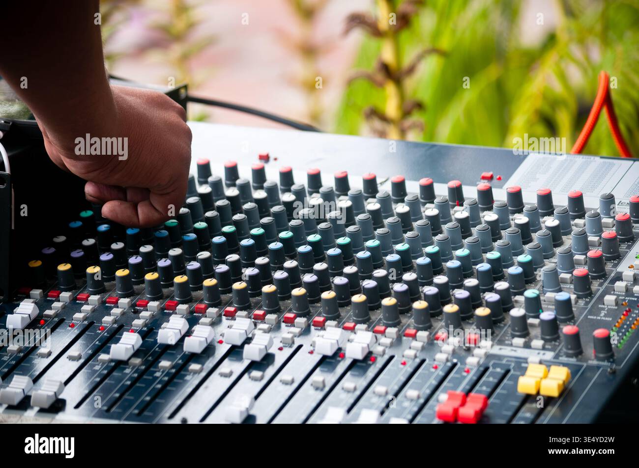 Professional audio engineer adjusting analog mixing console Stock Photo