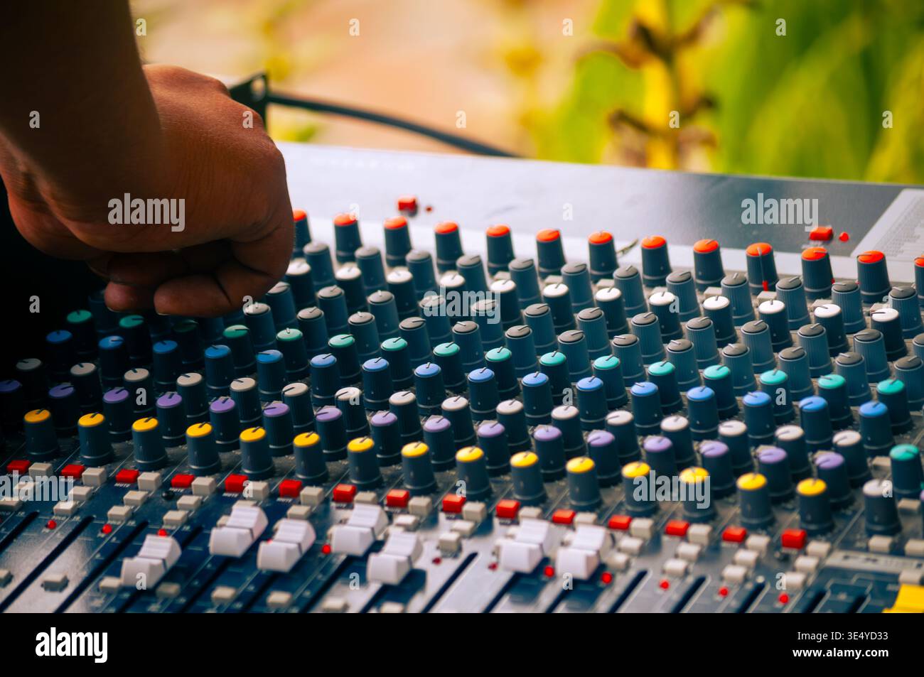 Professional audio engineer adjusting analog mixing console Stock Photo