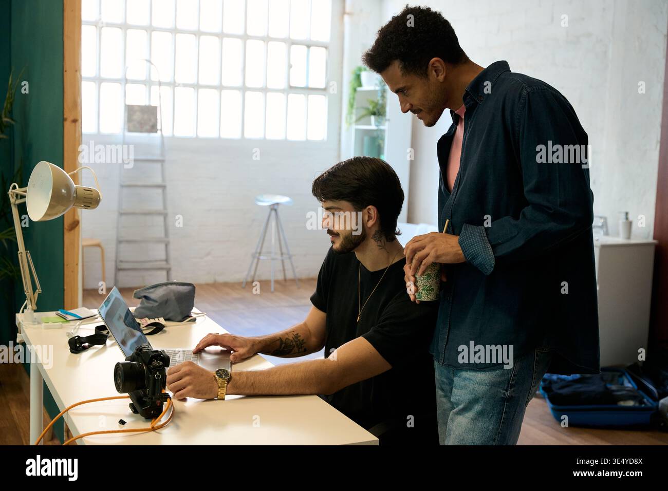 Creative men collaborating on computer in office Stock Photo