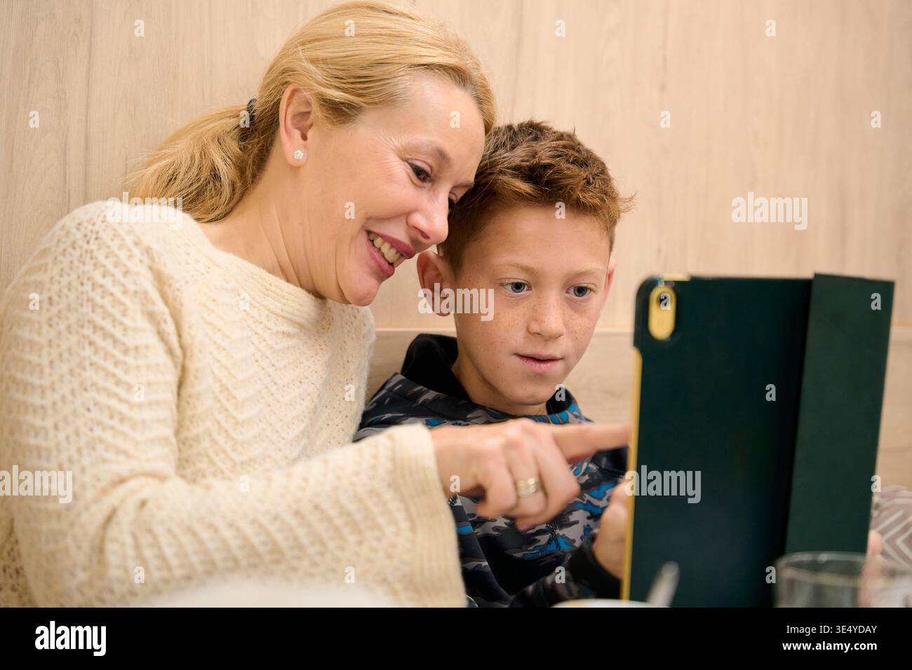 Mother and son learning together using tablet technology Stock Photo