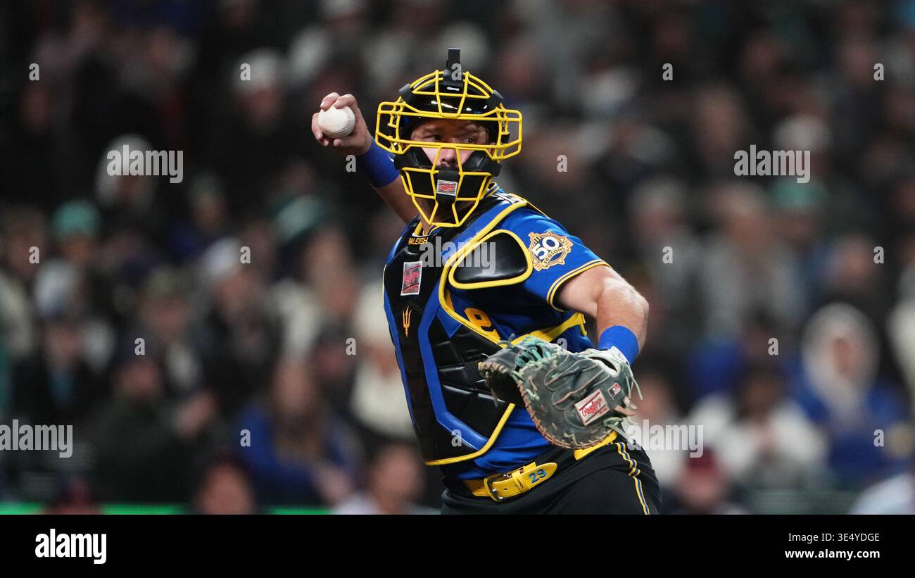 Seattle Mariners catcher Cal Raleigh throws to first base during a ...