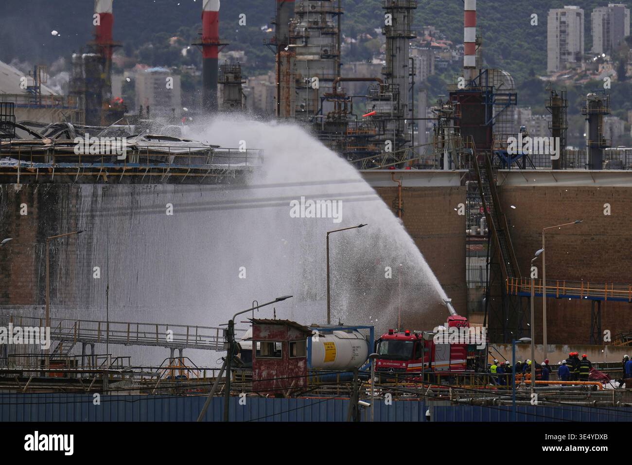 Firefighters work to extinguish a fire at the site of an Iranian ...
