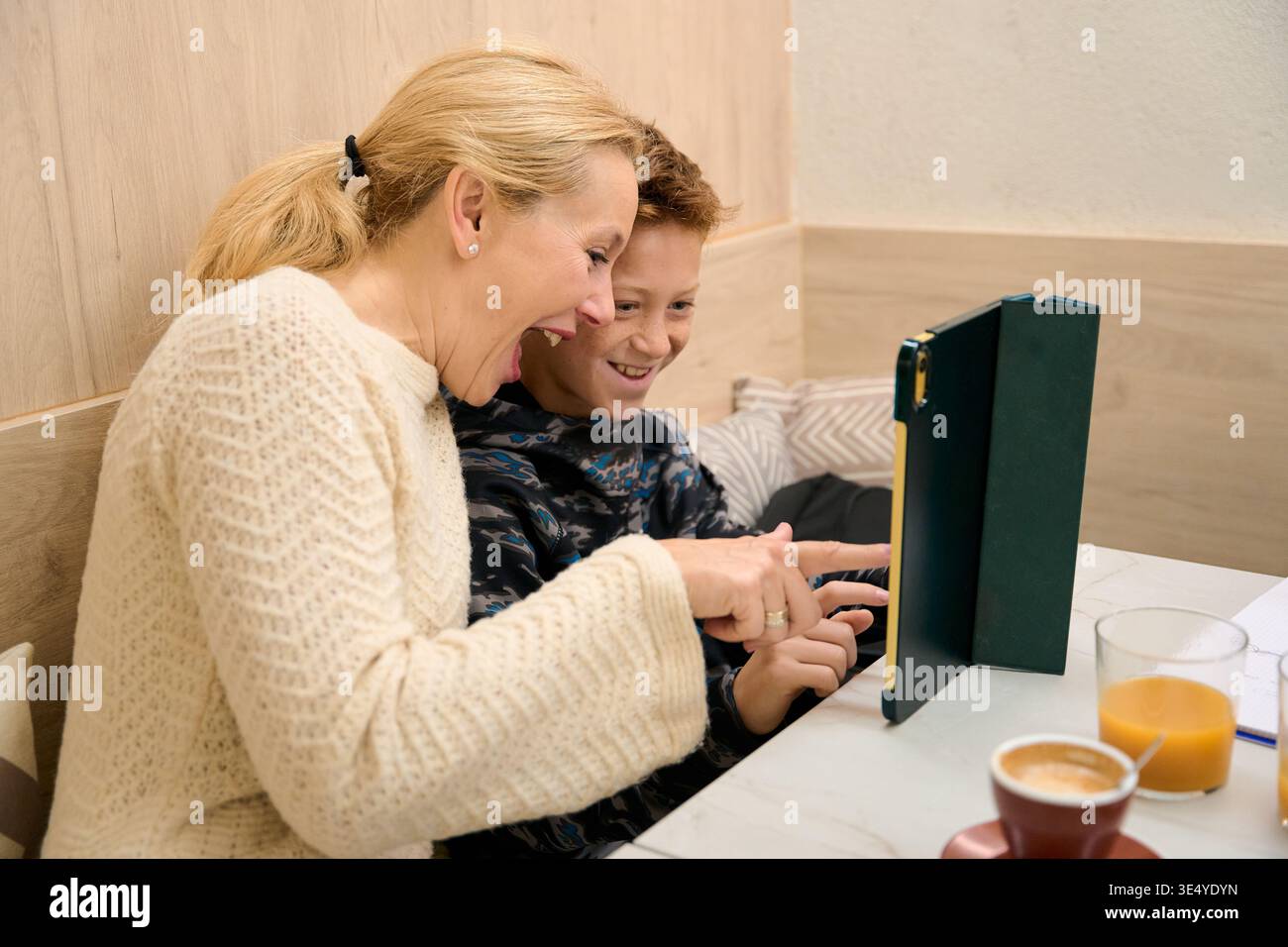 Mother and son laughing using digital tablet Stock Photo