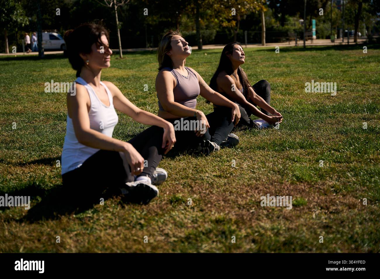 Women meditating outdoors practicing mindfulness in park Stock Photo